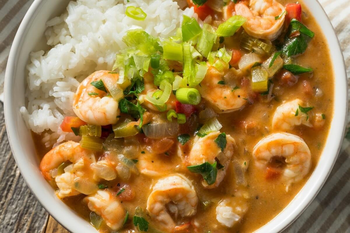 Bowl of shrimp étouffée served over rice with Cajun seasoning and fresh parsley
