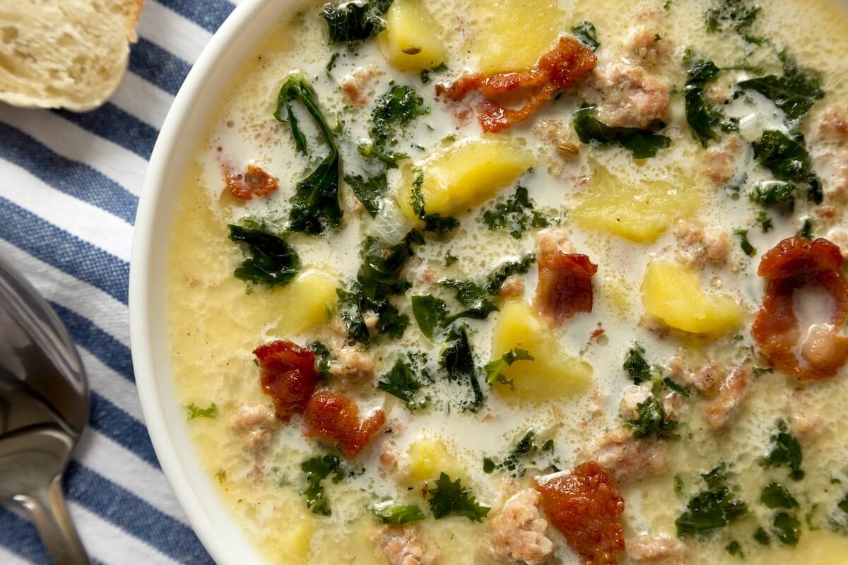 Creamy Zuppa Toscana soup with sausage, potatoes, and kale in a bowl — hearty fall dinner recipe