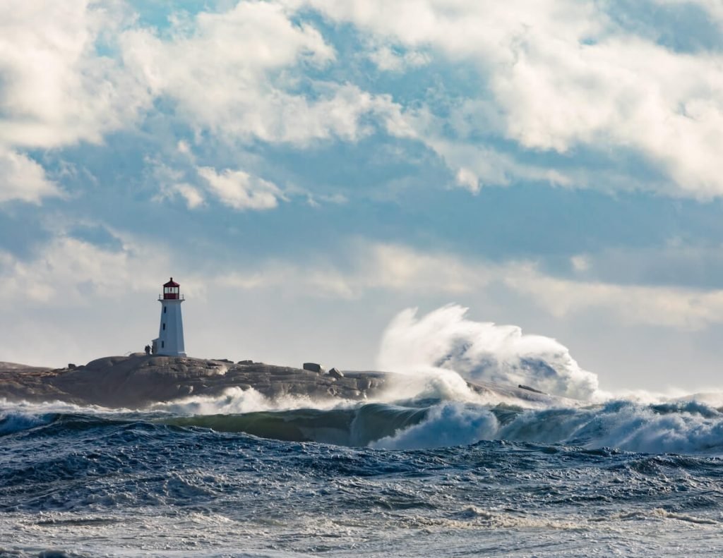 Lighthouse standing strong as waves crash around it, symbolizing trusting God in the middle of life’s storms.