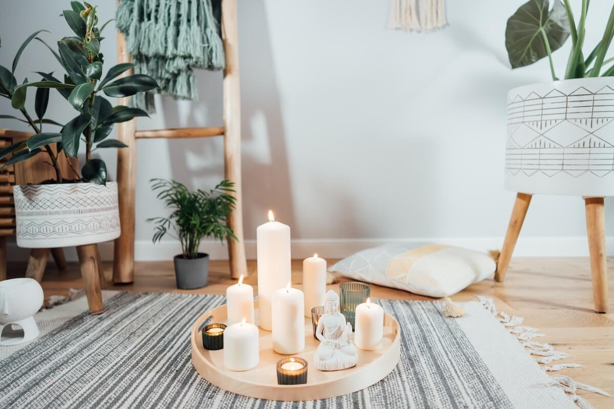 Cozy morning prayer space with candles, plants, and soft natural light, symbolizing peace, reflection, and quiet time with God.