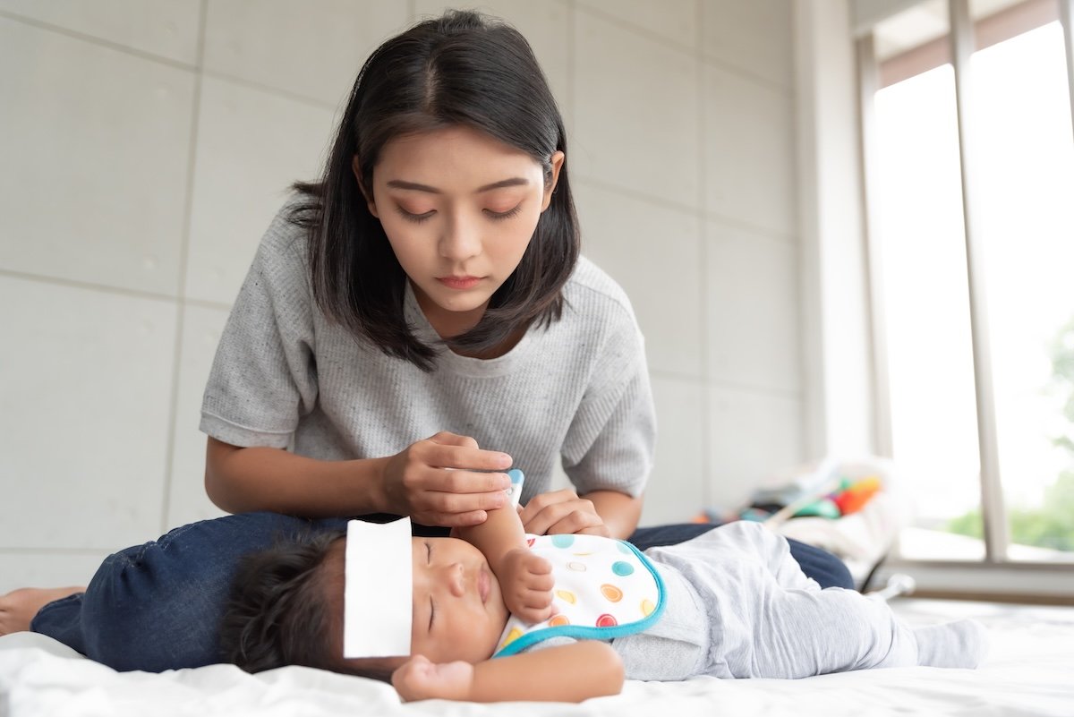 mother praying for sick baby