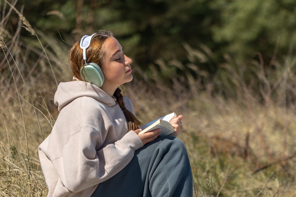 Woman listening to worship music outdoors.