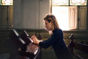 Woman praying alone in a church
