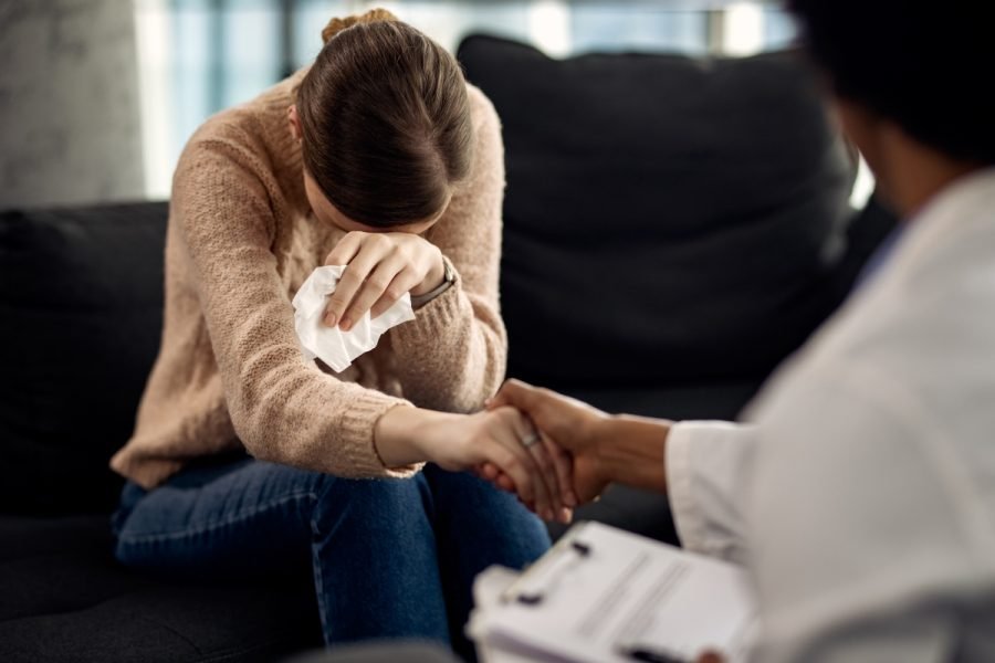 Woman crying during a therapy session.