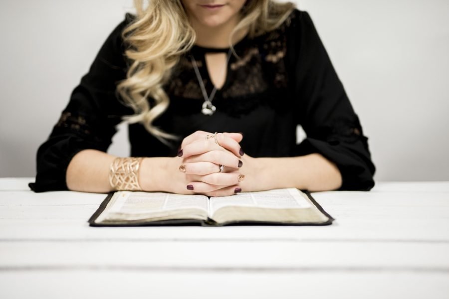 Woman praying over Bible