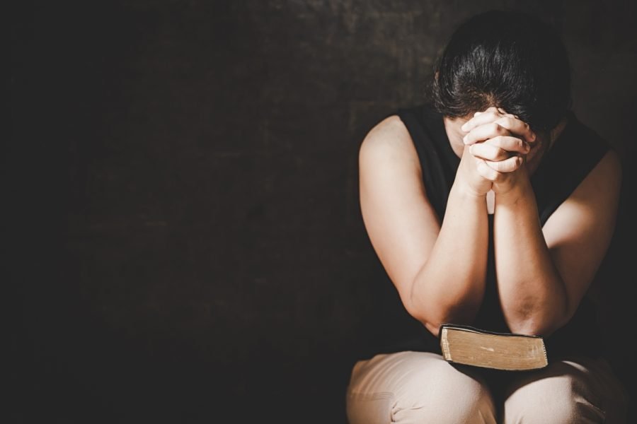 Christian life crisis prayer to god. Woman Pray for god blessing to wishing have a better life. woman hands praying to god with the bible. begging for forgiveness and believe in goodness.
