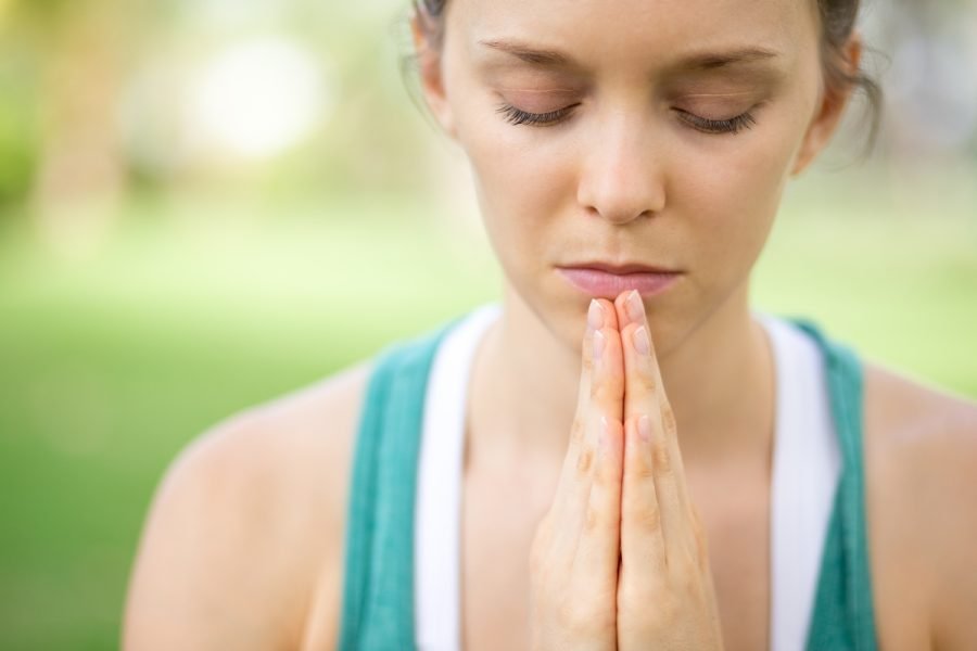 Woman seeking peace through prayer.