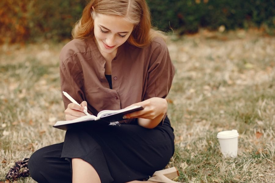 Woman writing in a journal.
